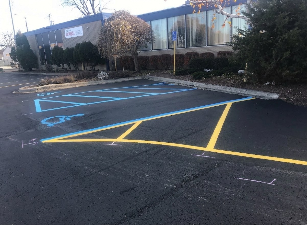 Fresh yellow and blue handicap parking lot striping on new asphalt
