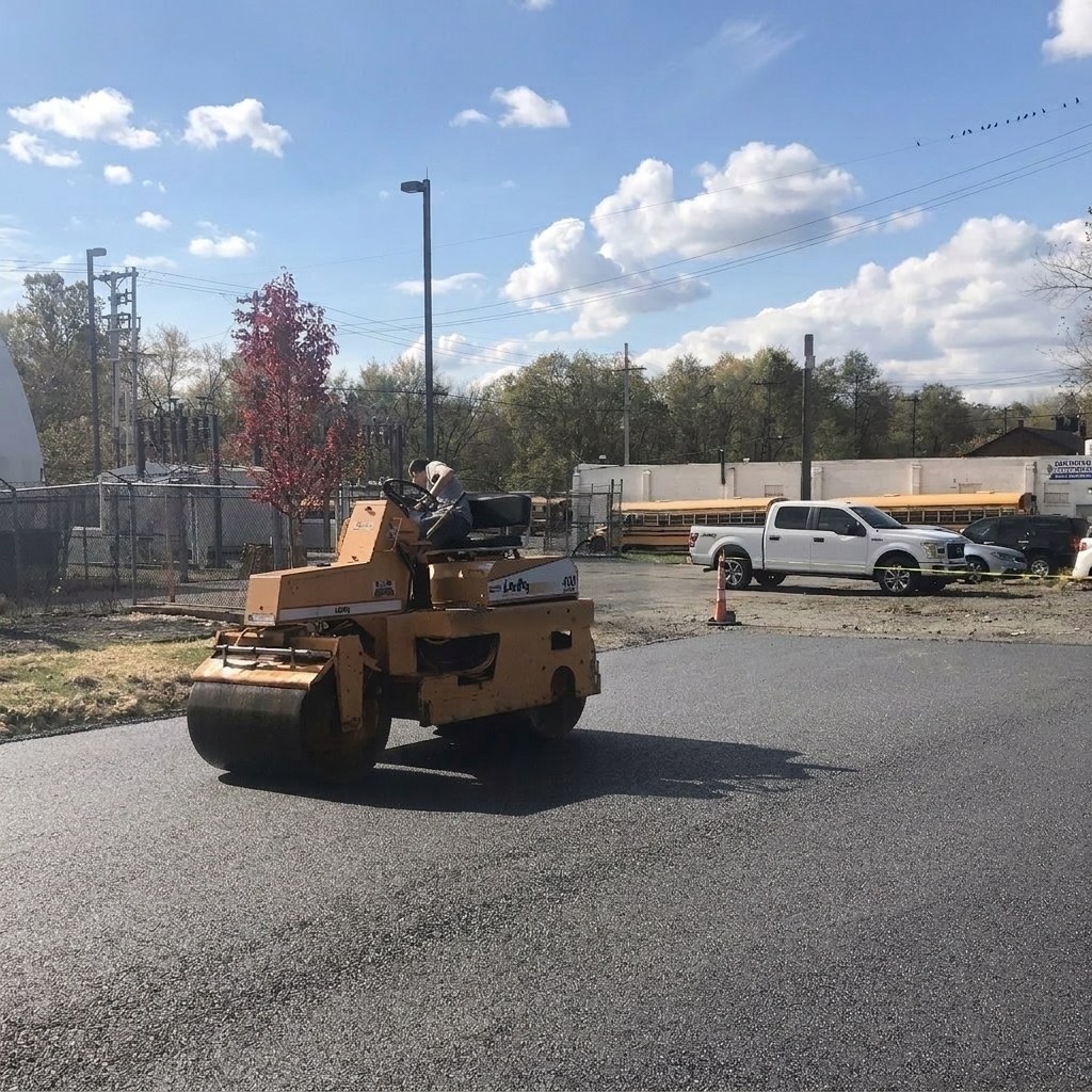 LeeBoy roller compacting fresh asphalt on an industrial lot